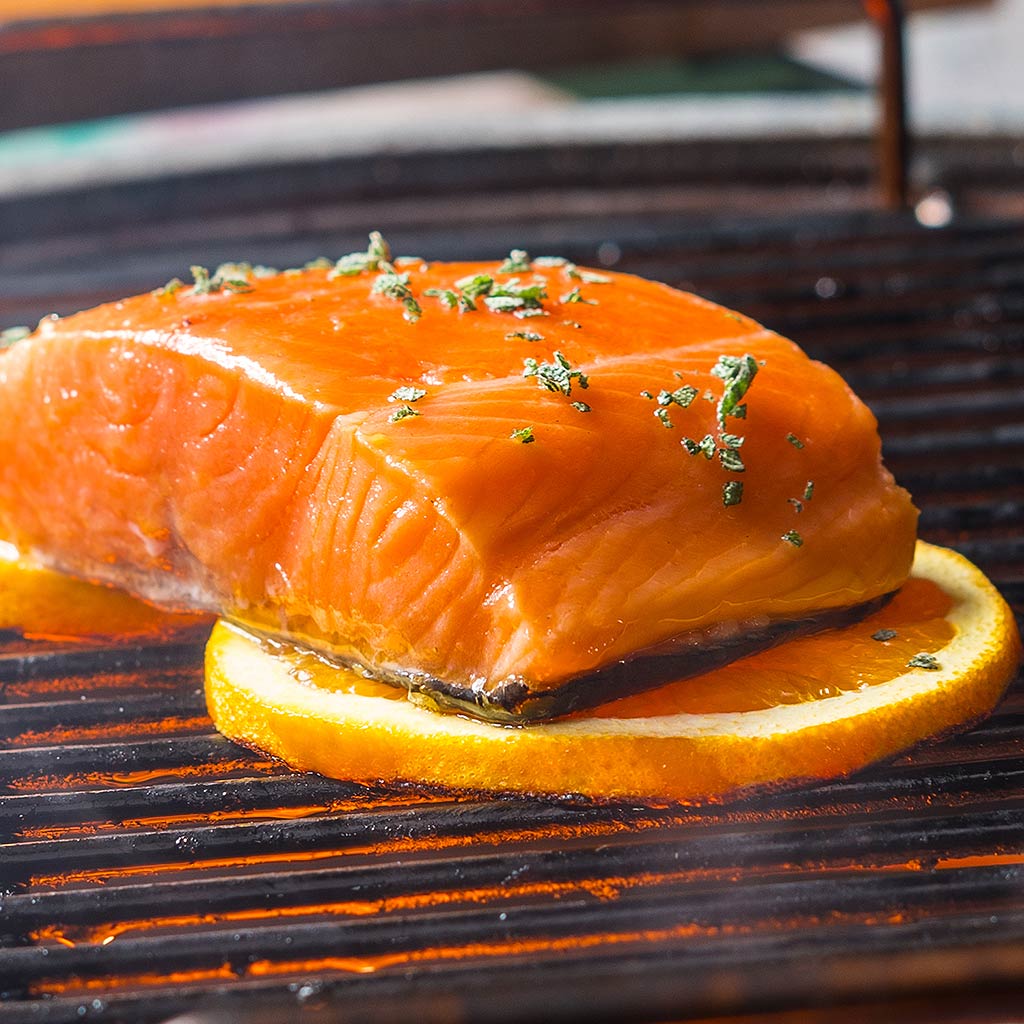 Grilled fish on orange slices